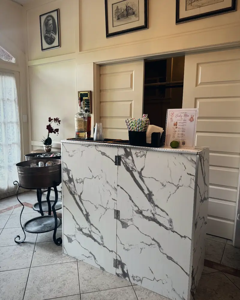 White marble bar with a baby shower cocktail menu